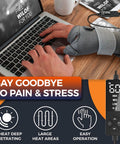 Person typing on laptop wearing gray Electric Thumb And Wrist Heating Pad For Hand Arthritis And Carpal Tunnel Relief.