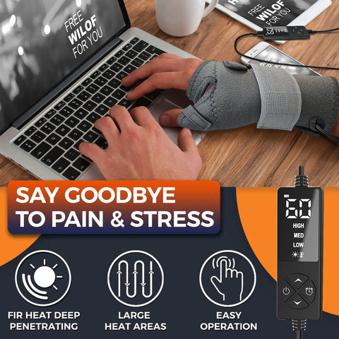 Person typing on laptop wearing gray Electric Thumb And Wrist Heating Pad For Hand Arthritis And Carpal Tunnel Relief.