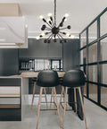 19.5-Inch Black 10-Light Iron Sputnik Chandelier hanging in modern kitchen setting with black cabinets and bar stools.