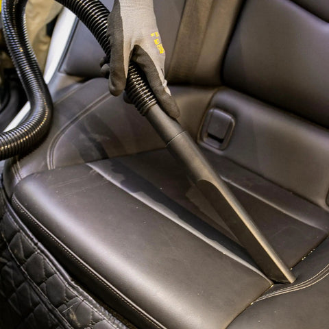 Pro Grade 6 Gallon Wet Dry Vacuum With 4 Peak HP Motor And Stainless Steel Tank cleaning car seats in silver and yellow.