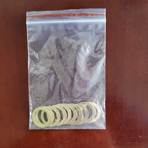 Front view of resealable plastic bag with 10 brass saw blade bushings, 7/8–5/8 inch, 1.0 mm thick