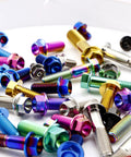 Titanium hex flange bolts with multicolor anodized finishes, close-up view.