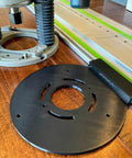 Guide Rail Adapter Fits Bosch 1617 Router Converts Plunge Or Fixed Base To Track Saw System For Dead On Cut Accuracy Uses Original Sub Base Screws For A No Sweat Install Designed And Built In America on a wooden surface next to a router.