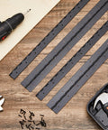 Four Pack 30 Inch Heavy Duty Piano Hinge Tough As Nails Continuous Hinges In Matte Black 304 Stainless Steel on wood surface with tools.
