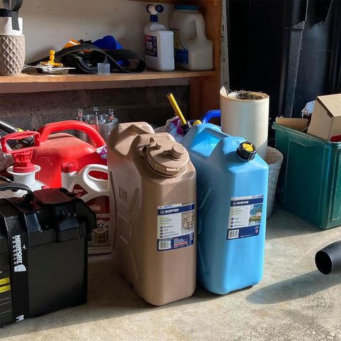 Portable 5 Gallon Military Style Water Jug For Camping And RVs Sand Colored Plastic Beverage And Hydration Dispenser For Outdoor Drinking And Emergency Survival next to blue jug.