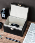 Faraday Box Key Fob Protector For Car Keys, RFID Signal Blocking Shield, open on table with car keys and newspaper nearby.