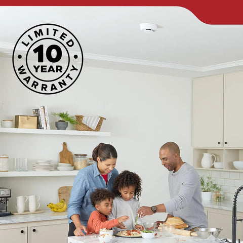 Family cooking in a kitchen with a Hardwired Smoke Detector With 10 Year Battery Backup And Loud Voice Fire Alert For Houses 120 Volt Plug And Play Wiring 3 Pack on the ceiling.