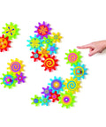 Colorful Magnetic Gear Building Set For Kids 4 To 8, 22 Piece STEM Learning Kit with child pointing at gears on white surface
