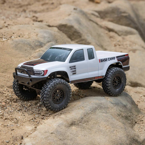 SCX24 Base Camp 4x4 Rock Crawler Ready To Run RC Truck Brushed on rocky terrain, white body, large tires, remote control included
