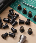 Heavy Duty Rubber Well Nuts With Solid Brass Sleeve Inserts, 1/4 20 X 3/4 Inch Length, 40 Pack on a workbench.