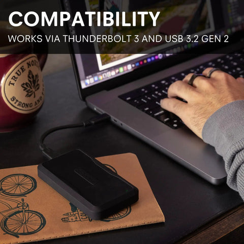 Beast 2TB External NVMe SSD With Thunderbolt 3 Ultra Fast 2800 MBs Read 2600 MBs Write For 4K 8K Editing VR And Big Media Backups, black aluminum enclosure on laptop desk