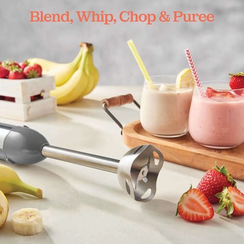 500 Watt Electric Hand Blender With Turbo Boost And Sharp Stainless Steel Blades For Smoothies Soups Purees And Baby Food Detachable Base Grey on kitchen counter with fruits and smoothies.