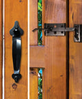 Rock Solid Iron Thumb Latch With Matte Black Galvanized Steel Finish Six Inch Throw mounted on wooden gate.