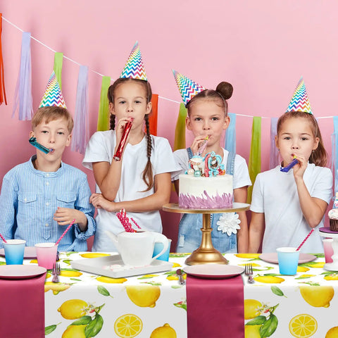 Children celebrating at a party with Three Pack Lemon Tablecloths Outdoor Waterproof Rectangle Cover For Indoor And Outdoor Use 54 By 108 Inches Oil Proof Summer Party Kitchen Dining Picnic Barbecue Patio.