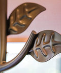 Rustic Oil Rubbed Bronze Floor Lamp With Leaf Finial And Gold Tapered Shade close-up of leaf finial detail
