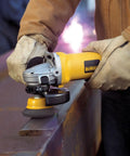 Worker using 3 Inch Knotted Cup Brush With 5 8 11 Arbor For Metal Grinding Removal on steel surface with angle grinder