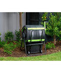 Dual Chamber 48 Gallon Compost Tumbler With Geared Rotation And Cart Access in yard for easy turning of kitchen scraps