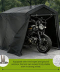 All Weather Outdoor Storage Shed Tent With Waterproof Cover Windproof Portable Carport Garage Shelter Roll Up Zipper Door And Vents UV Resistant Canopy For Motorcycle Bike Lawn Mower Tools 5 By 7 Point 2 By 5 Point 4 Feet covering a motorcycle in a driveway with secure frame support