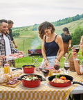 Portable Lightweight Nonstick Cast Iron Cookware Set With Glass Lids And Nylon Utensils 4 Piece Outdoor Camping Pots And Pans in use at a picnic