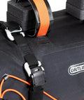 Handlebar Pack For Bike With Dual Roll Closures For Quick Access, Camlock Strap Hook, Easy Steering Tube Belt Adjustment, Air Release Valve With Pull String, 15 Liter Capacity, Compact, Ride Ready Storage close-up detail of strap and hook