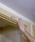 Using Heavy Duty Cleaning Wipes For Every Surface And Hands, 90 Count to remove crayon marks from a door frame indoors.