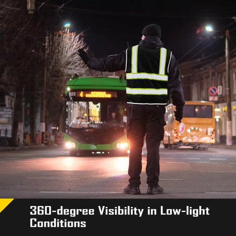 Heavy Duty Reflective Mesh Safety Vest For Men In Black With Nine Roomy Pockets And Bright High Visibility Markers For Construction Job Sites Serving Up Top Tier Airflow And Zero Hassle Comfort worn by a worker directing traffic at night.