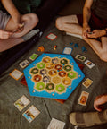 Premium Island Settlement Building Strategy Board Game For Families And Crew Ages 10 Plus Master Resource Trading Expand Territories For An Epic Hella Fun Tabletop Adventure, with game pieces and cards on the floor.