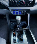 Dashboard view of Toyota with Easy Install No Fuss 12V Push Button Switch With Wire Kit installed, showing blue LED lights.