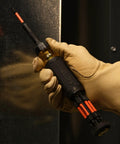 Gloved hand holding 15-In-1 Multi-Bit Ratcheting Screwdriver Set With Impact-Rated Bits, 7 ProFlex Double-Ended Tips, 1/4-Inch Nut Driver