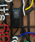Close-up of a metal frame neon sign 17 inch by 13 inch real glass neon light, multi-colored glow, showing electrical components.