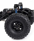 Close-up of One Tenth Scale RC Crawler Chassis Kit With 313mm Wheelbase, showcasing nylon frame, 35T motor, and rugged tires.