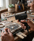 Close-up of Dual Watt Soldering Gun 400 And 150 Heavy Duty with Trig R Heat Control in home jewelry making workspace.