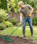 Person using 30 By 10 Inch Lawn Leveling Rake For Soil Sand Dirt Beefed Up Heavy Duty Ground Leveler in garden