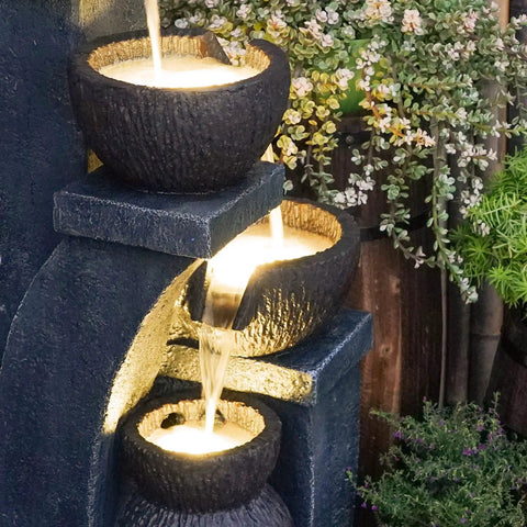 Close-up of four bowl outdoor water fountain with LED lights, modern polyresin floor fountain for garden and patio, three-tier flow