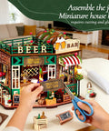 Hands assembling DIY Mini Beer Shop House Kit For Adults 3D Wooden Puzzle Tiny Home With Furnished Interior Book Shelf Decor Craft