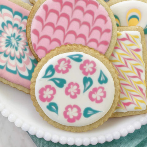 Top Shelf Cookie Decorating Tools Set Featuring Etching Wand Triple Comb And Flexible Silicone Scraper For Bakin Crews Crafting sleek floral icing designs on cookies.