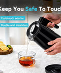 850Ml Small Electric Kettle With Temperature Control Your Quick Heat Buddy 800W Fast Boil Double Wall 304 Stainless Steel Five Temperature Presets Auto Shut Off Safe For Tea And Coffee Compact Kitchen Office Dorm Black being used to pour hot water into a cup of tea on a kitchen counter.