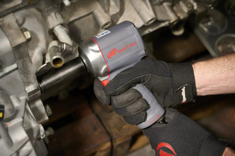 Half Inch Air Impact Wrench With Quiet Technology Up To 650 Foot Pounds Of Torque Ultra Compact And Light Weighs About Two Point Four Pounds Max Control For Big Jobs Like Heavy Duty Assembly And Suspension Work being used on machinery
