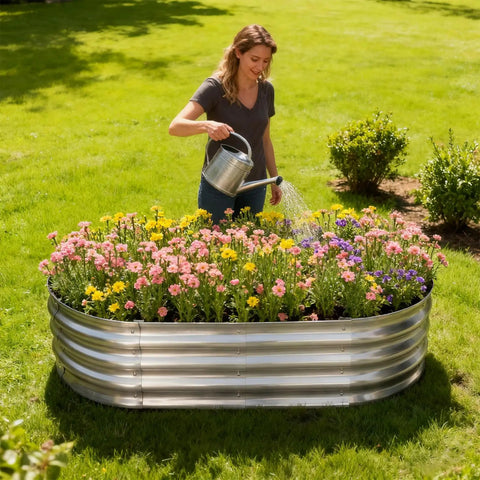Person watering plants in a Galvanized Raised Garden Bed Kit 4By2By1Ft Oval Planter Boxes For Outdoor Garden on grass
