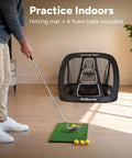 Golfer using Chipster PRO Golf Chipping Net For Indoor And Outdoor Practice With Pop-Up Target, Hitting Mat, Four Foam Balls.