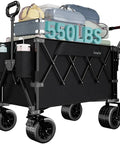 Heavy Duty Collapsible Wagon Cart 550 Lbs Capacity With Drop Down Tailgate Dual Handles Big Wheels Foldable Utility Cart For Camping Fishing Gardening Shopping Black loaded with gear and bags.