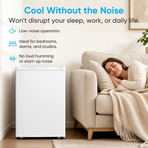 White 3.0 Cu Ft Upright Freezer With 7 Adjustable Temp Settings Compact Mini Freezer Space Saving Storage Solution next to a couch in a living room.