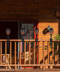 Heavy Duty Deck Torch Clamp Set Black Metal Rail Mounts For Outdoor Torches attached to wooden porch railing