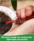 Hand using Six Piece Mini Seed Sowing Dispenser Kit With Two Transplanting Tools Hand Spreader Garden Seed Planter on pot soil