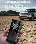 Hand holding Portable Tire Inflator Air Compressor 150 PSI Cordless Pump With LED Light And Digital Pressure Gauge near SUV
