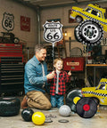 Man and child with Route 66 Retro Party Balloons Kit With Vintage Car Tire Decor And Vinyl Record Foil Balloons Shield Sign Old School Road Trip Vibes