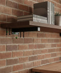 Multipurpose Black Steel Shelf Brackets For Garage, Kitchen And Workshop supporting a wooden shelf on a brick wall.