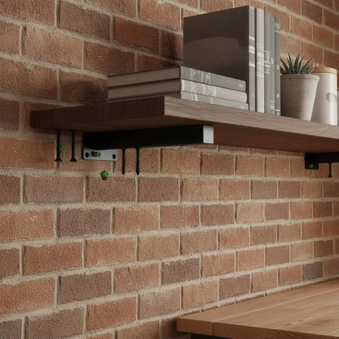 Multipurpose Black Steel Shelf Brackets For Garage, Kitchen And Workshop supporting a wooden shelf on a brick wall.