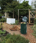 Large 34 Gallon Collapsible Garden Compost Bin With Lid For Yard Waste And Kitchen Scraps Durable Thick Polyethylene Tumbler Bin For Outdoor And Indoor Composting in a garden setting