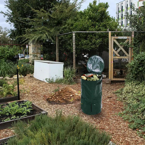 Large 34 Gallon Collapsible Garden Compost Bin With Lid For Yard Waste And Kitchen Scraps Durable Thick Polyethylene Tumbler Bin For Outdoor And Indoor Composting in a garden setting